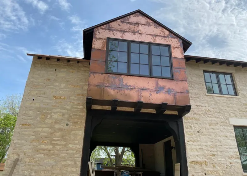 Copper metal panel facade on a stone building for Metal Roof Coating in Greenwood